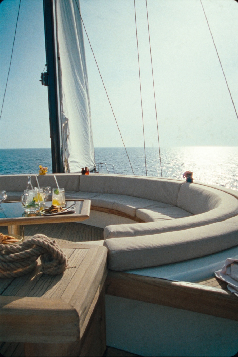 The lounge deck of a private sailing yacht at golden hour
