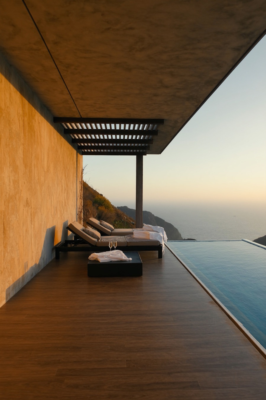 A private honeymoon villa terrace and infinity pool at golden hour