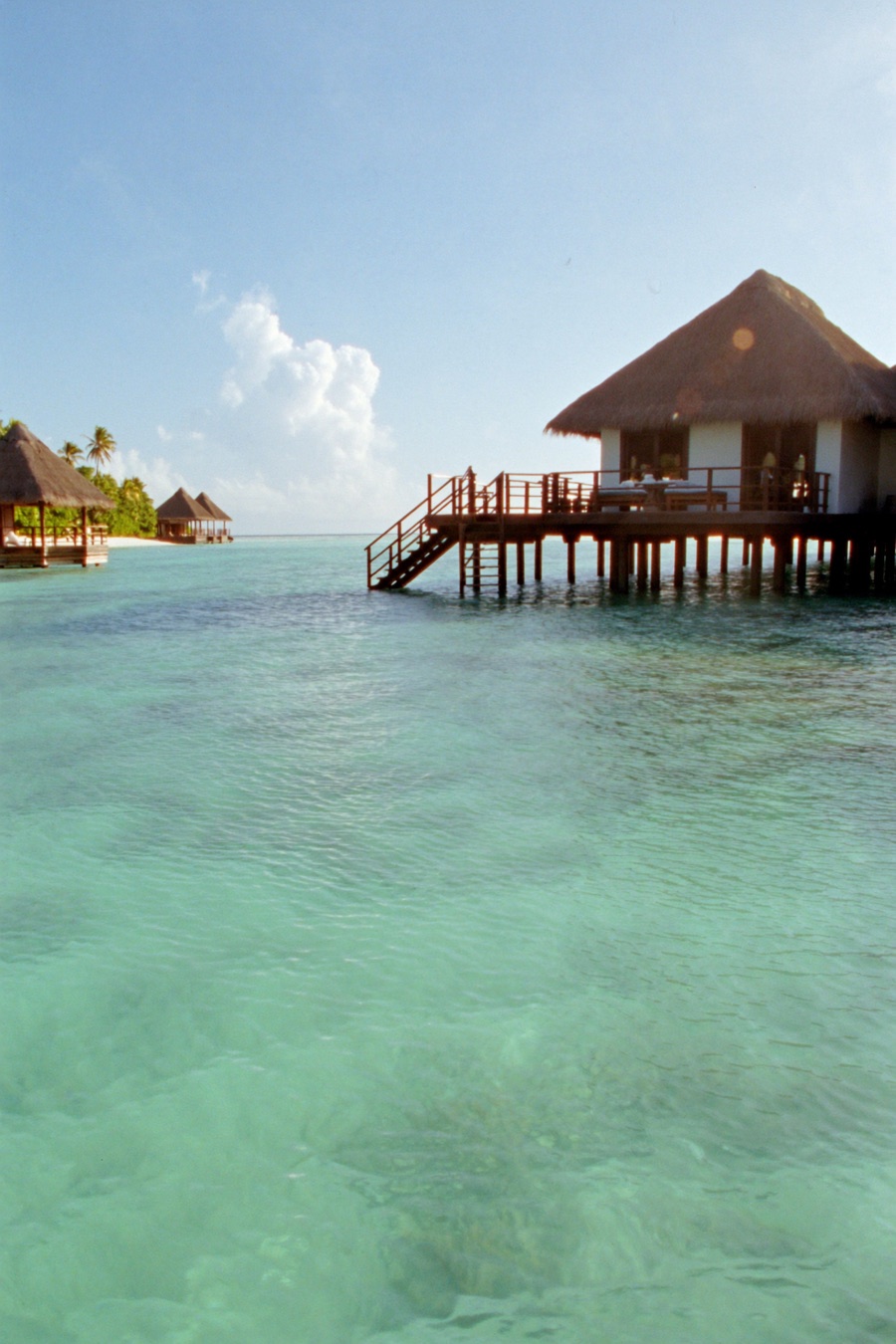 An overwater villa above a turquoise lagoon, Maldives